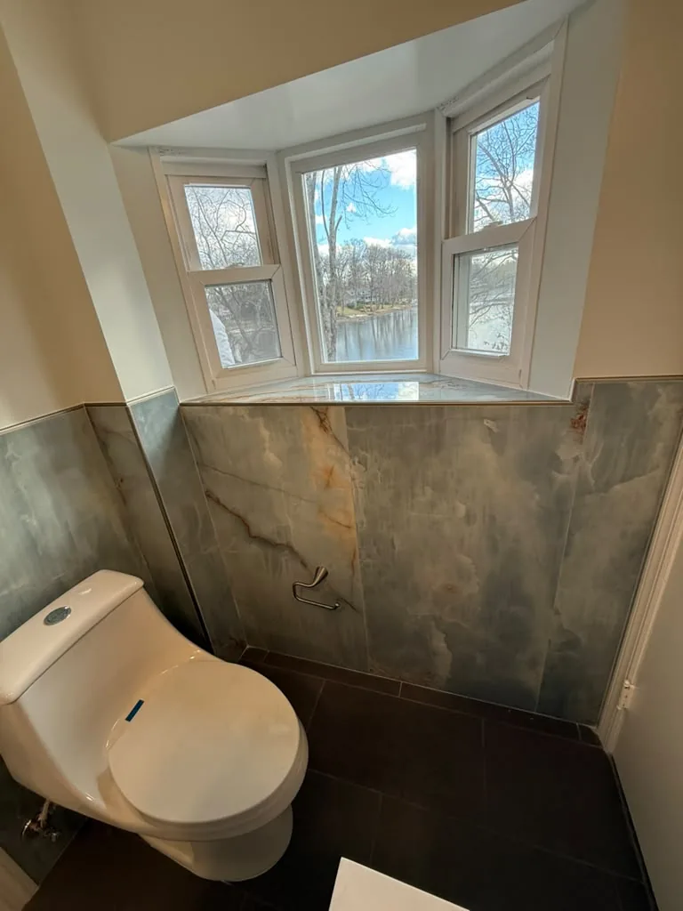 Bathroom with stone wall tile and bay window