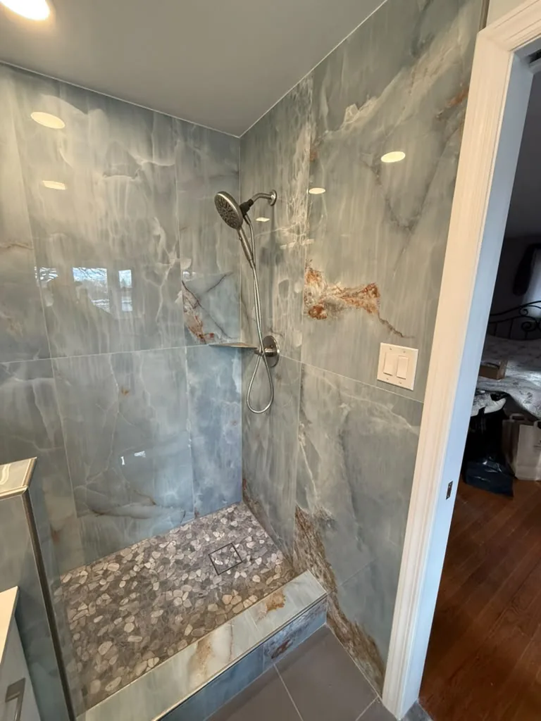 Finished shower with large format stone slab walls