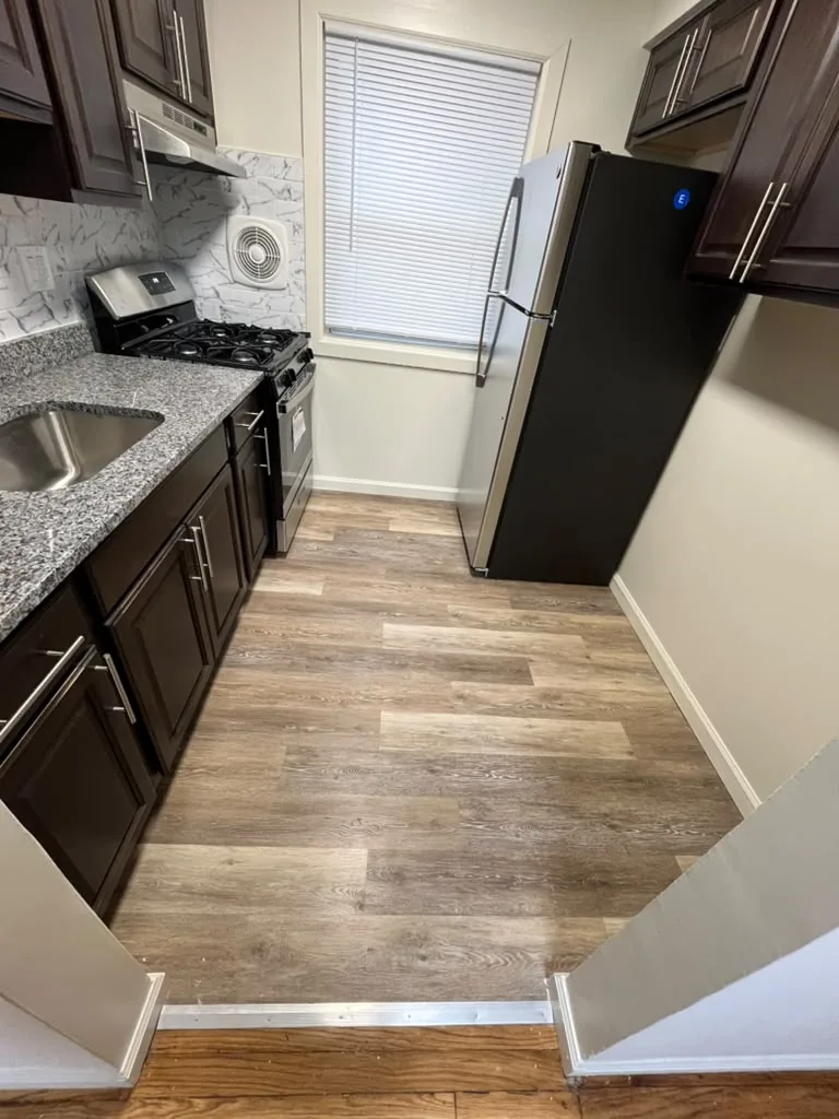 Espresso kitchen with granite counters and undermount sink