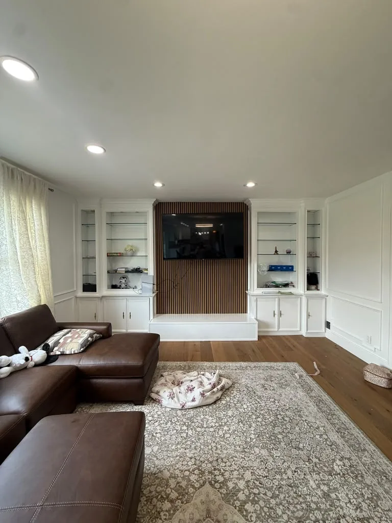 Living room with fine finish painting, built-in cabinetry and refinished floors